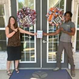 man and woman stand by a door