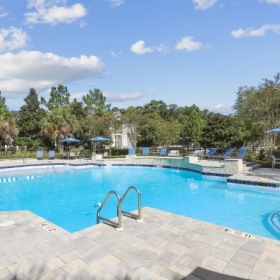 The Oakley at Saraland's community resort-inspired pool with ample lounge seating  on deck The Oakley at Saraland's community resort-inspired pool with ample lounge seating  on deck
